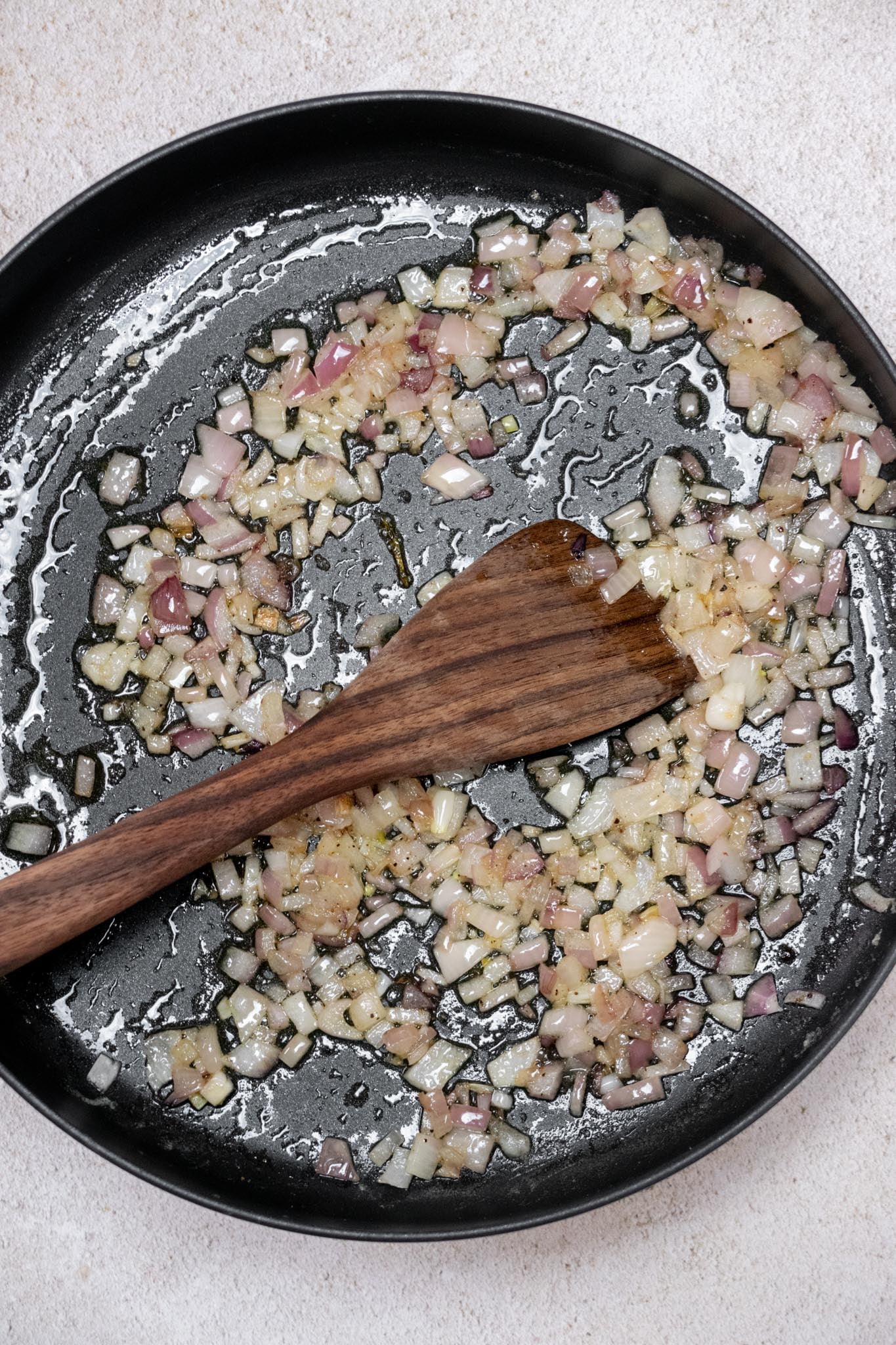 Cook pasta until al dente, reserving some pasta water. Meanwhile, melt butter in a large sauté pan and cook the onion with salt and pepper until softened, about 5–7 minutes.