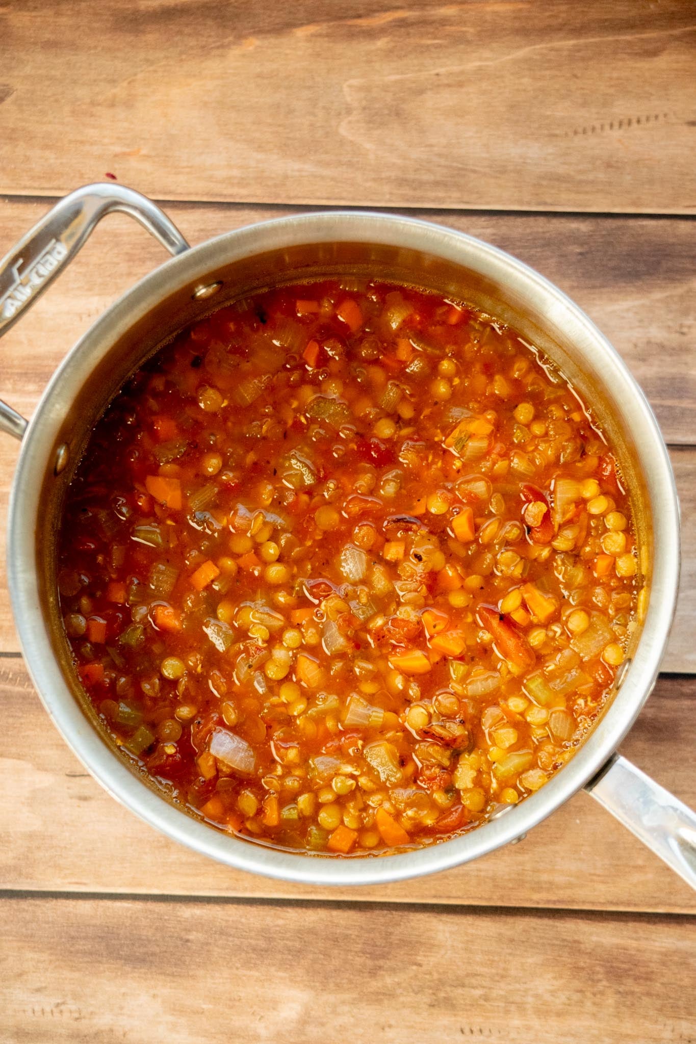 Simmer the soup. Bring to a boil, then reduce the heat to a gentle simmer. Cover partially and cook for 40–50 minutes, stirring occasionally, until the lentils are tender.