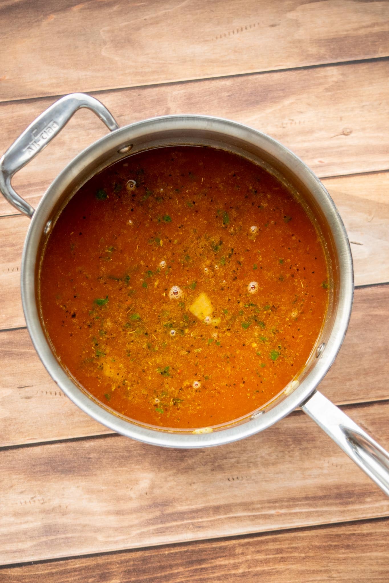 Add the lentils and liquids. Stir in the green lentils, fire-roasted tomatoes, and vegetable stock.