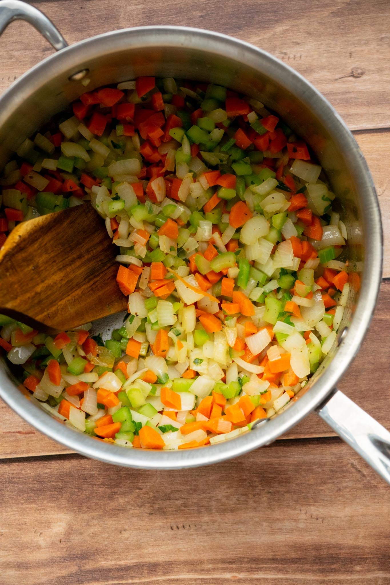 Sauté the vegetables. Heat the olive oil in a large soup pot over medium heat. Add the carrots, celery, and onion and cook for 6–8 minutes, stirring occasionally, until they begin to soften.