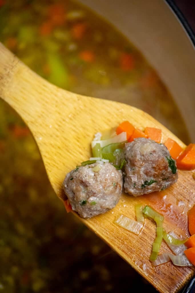 once boiling, reduce heat to medium-low, and add meatballs and accumulated juices. Cover and simmer 20 minutes. You can add pasta as well, or prepare separately. 