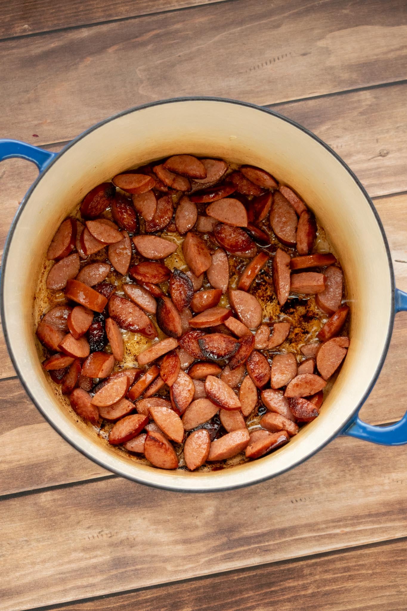 Brown the kielbasa. Heat the olive oil in a large Dutch oven or stockpot. Add the sliced kielbasa and cook until well browned on both sides. Remove and set aside.