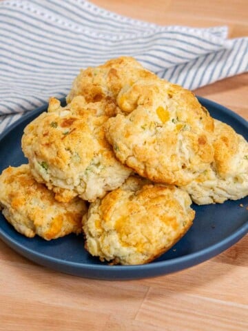 cheddar cheese biscuits on a serving plate.