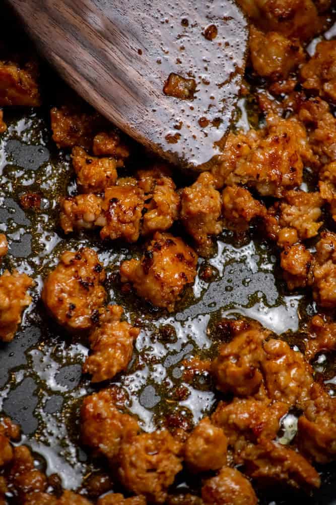 Break up sausage and cook until well browned.