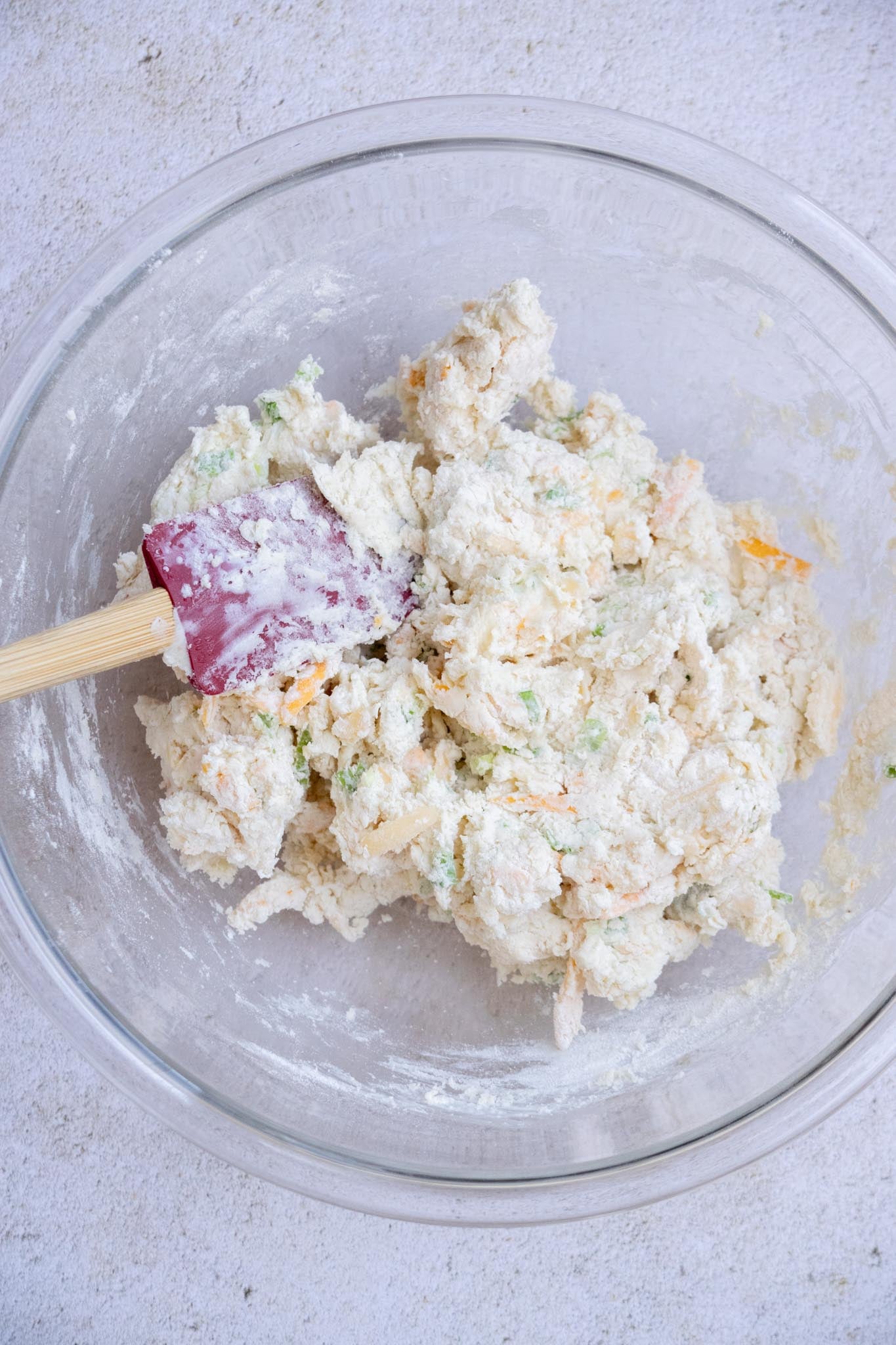Gently fold with a wooden spoon or spatula until a loose dough forms.