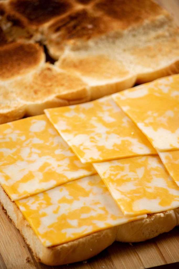 layer sliced Colby cheese on bottom buns