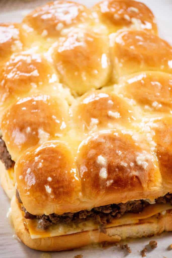 add top buns and baste with garlic butter 