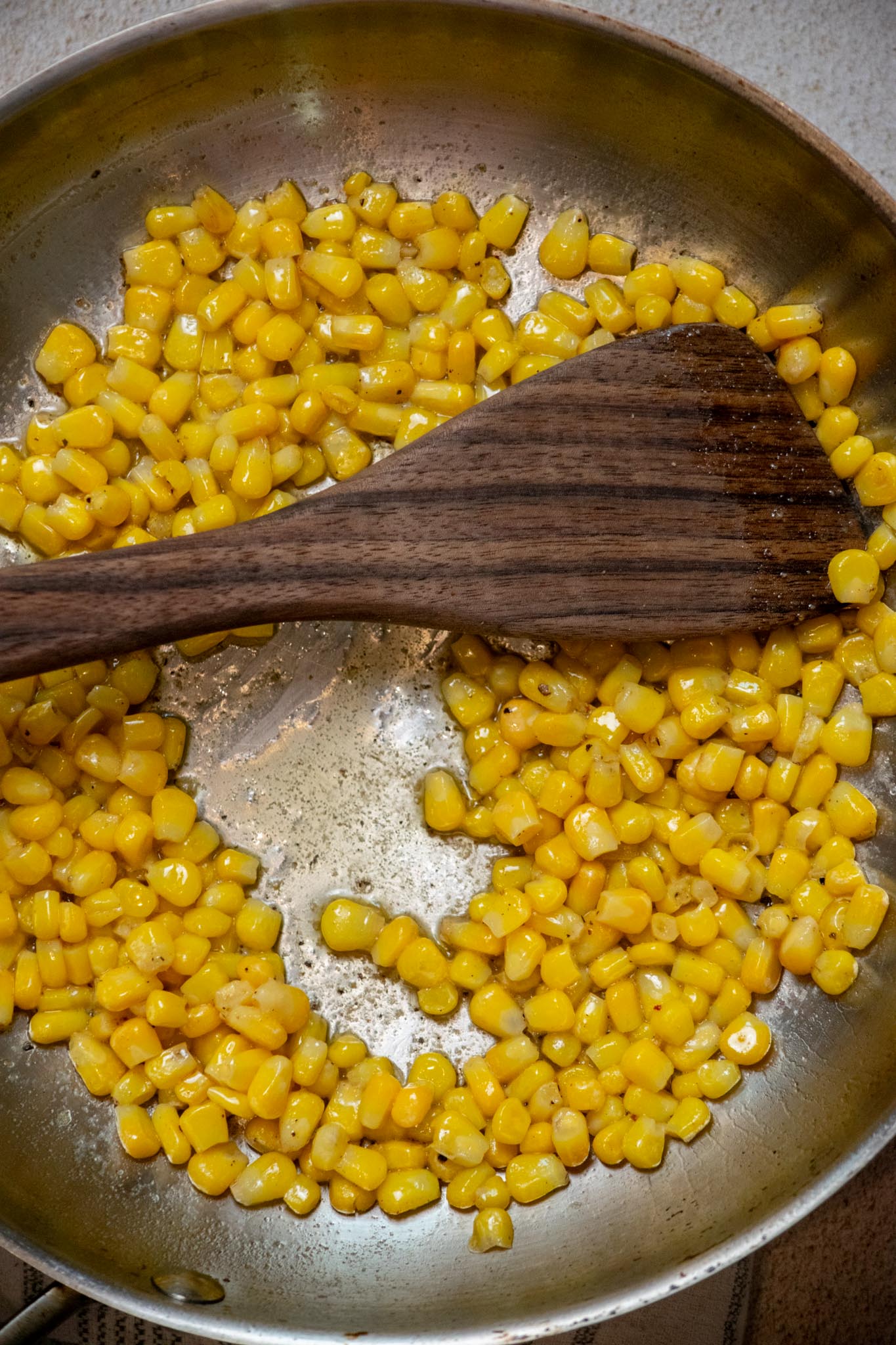 Melt butter in a medium frying pan, then add corn, season with salt and pepper, and cook 2-3 minutes, until just warmed through.
