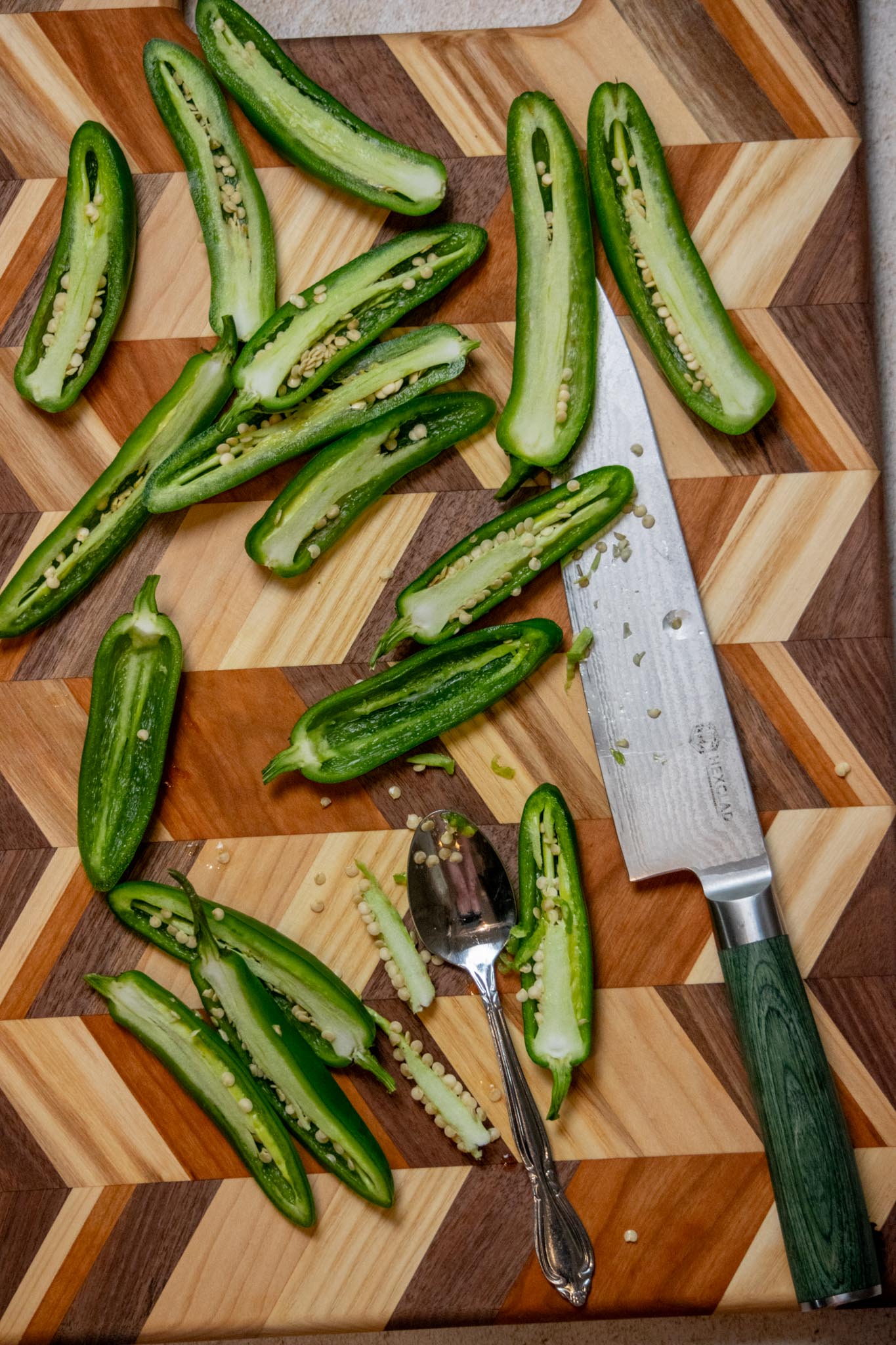 Preheat the oven to 375°. Slice the jalapeños in half lengthwise, and remove the seeds and ribs carefully with a spoon,.