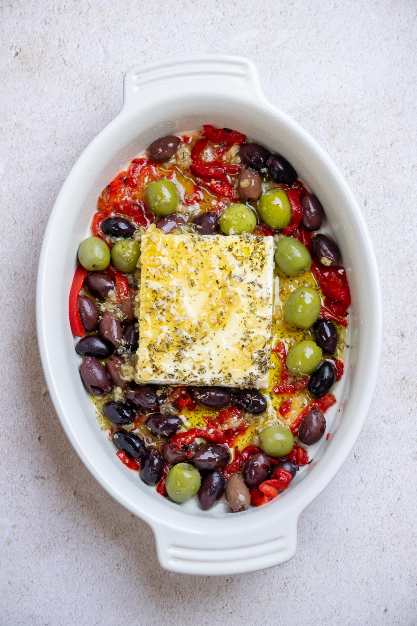 Pour Mixture over the feta, olives, and peppers, and season with salt and pepper.