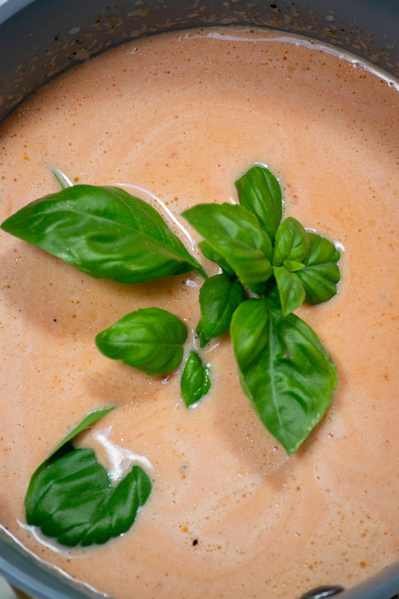 Infuse with basil. Reduce the heat to low, add the fresh basil, and simmer for about 10 minutes, stirring occasionally.