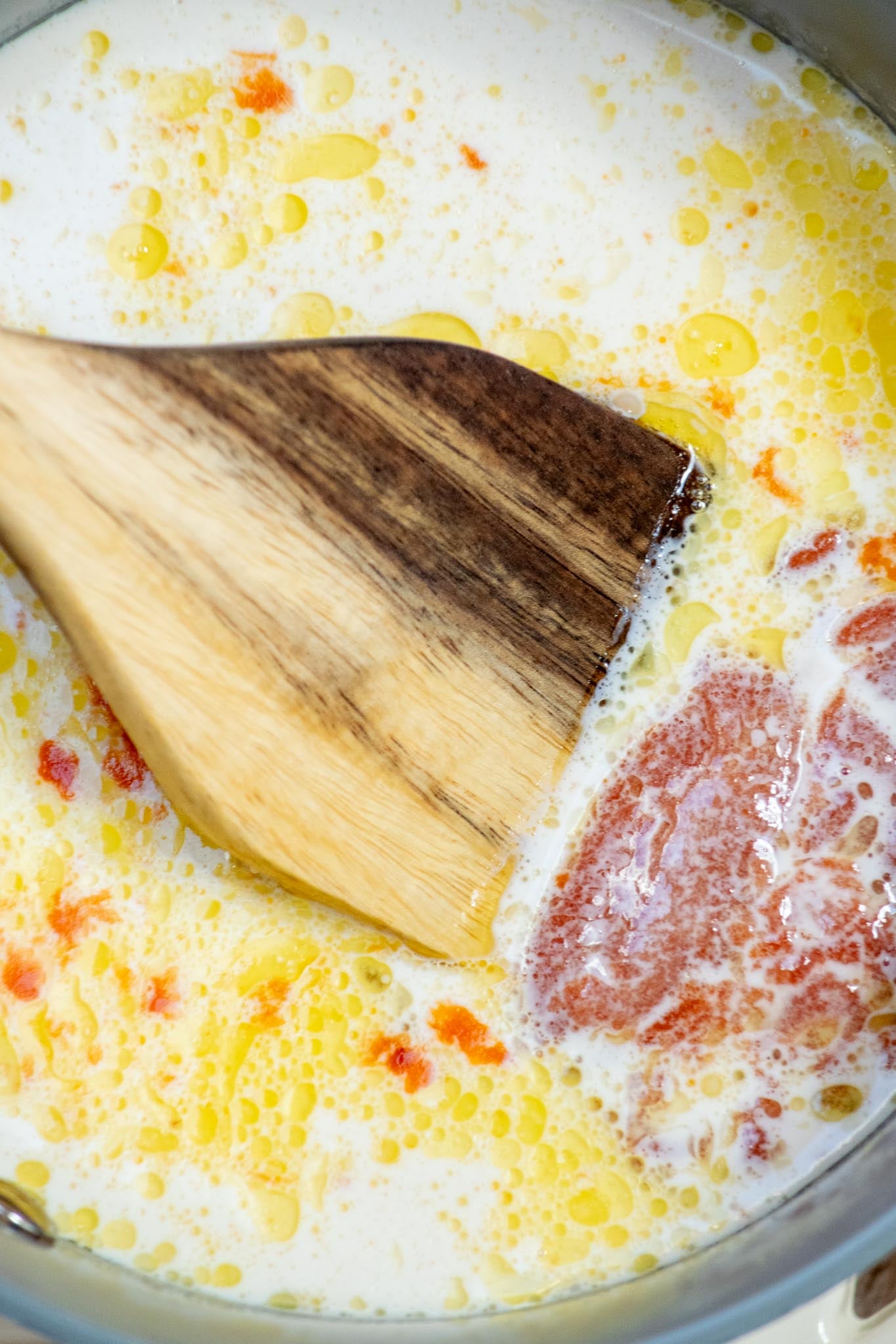 Add the soup and dairy. Stir in the condensed tomato soup, milk, heavy cream, salt, and pepper until smooth and combined.