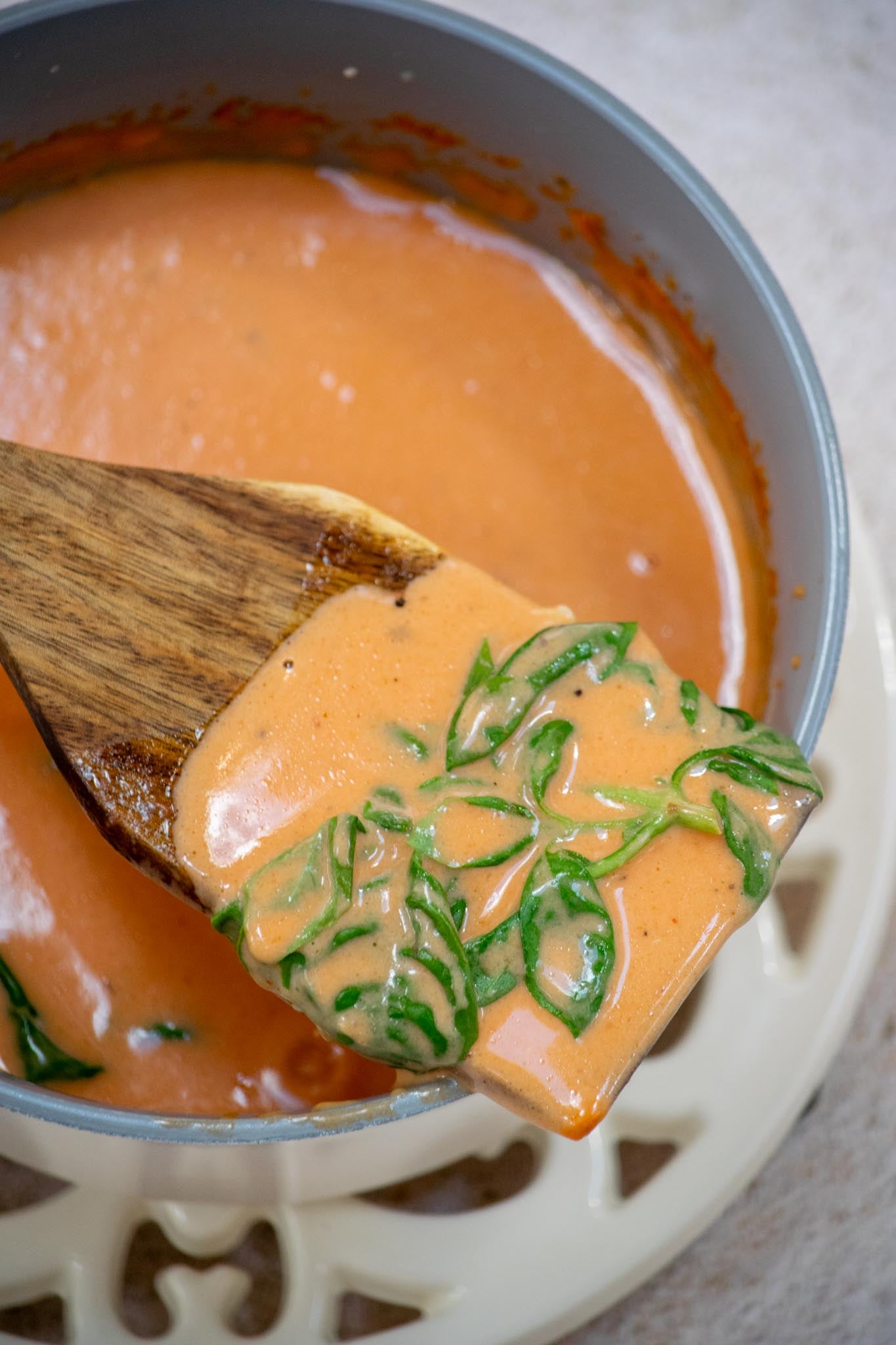 Finish and serve. Remove the basil, taste and adjust the seasoning if needed, then serve warm.
