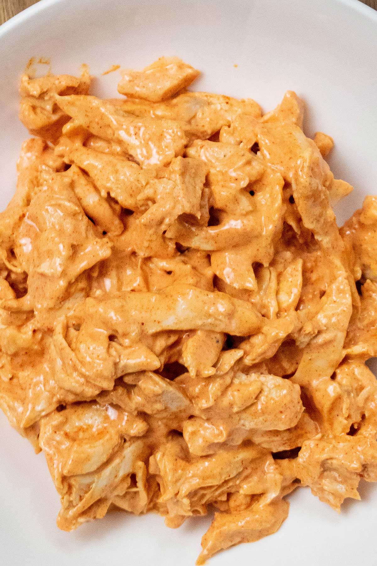 Make the buffalo chicken.
Mix the shredded chicken with blue cheese dressing, hot sauce, and smoked paprika until evenly coated.