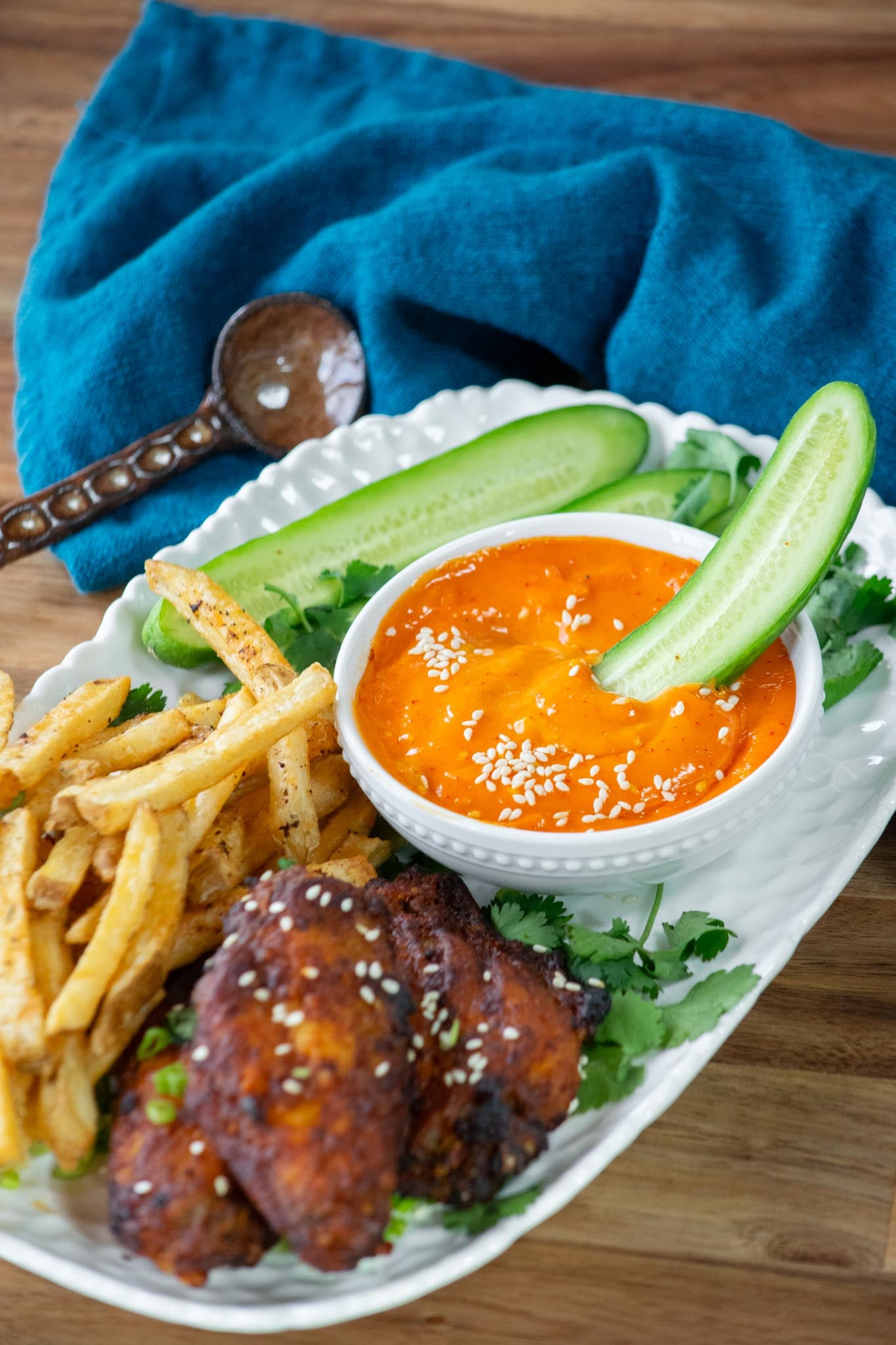Gochujang mayo wit chicken wings, fries, and cucumbers