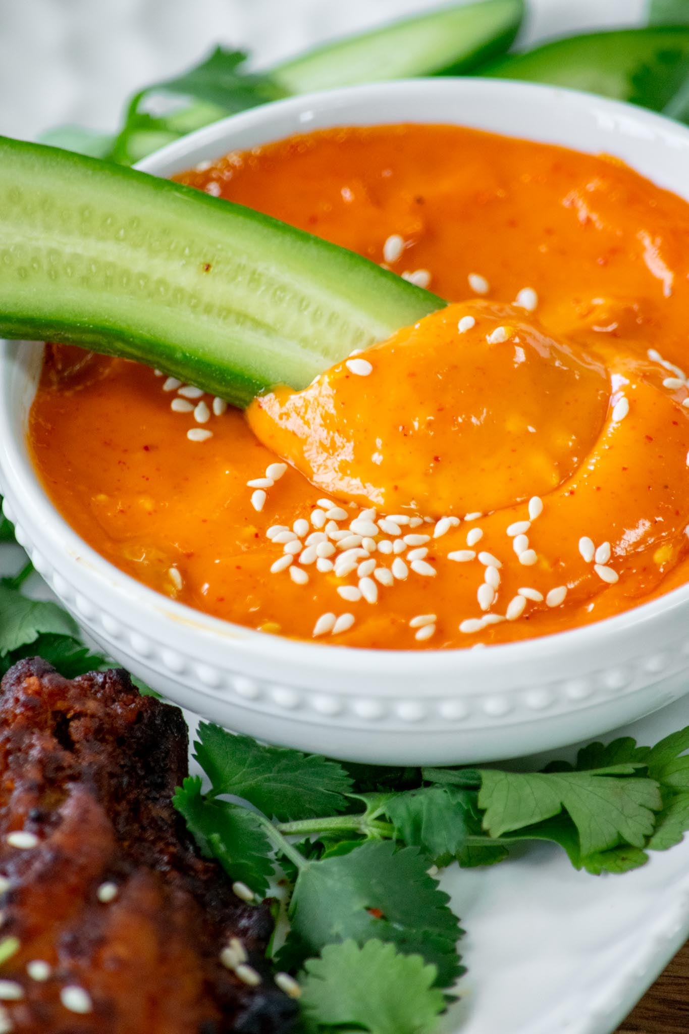 dipping cucumber into Gochujang Mayo