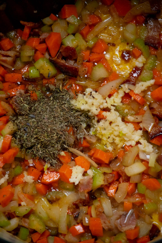 stir in the garlic, thyme, and Herbs de Provence (if using) and cook one minute, until just fragrant, to bloom the spices. 