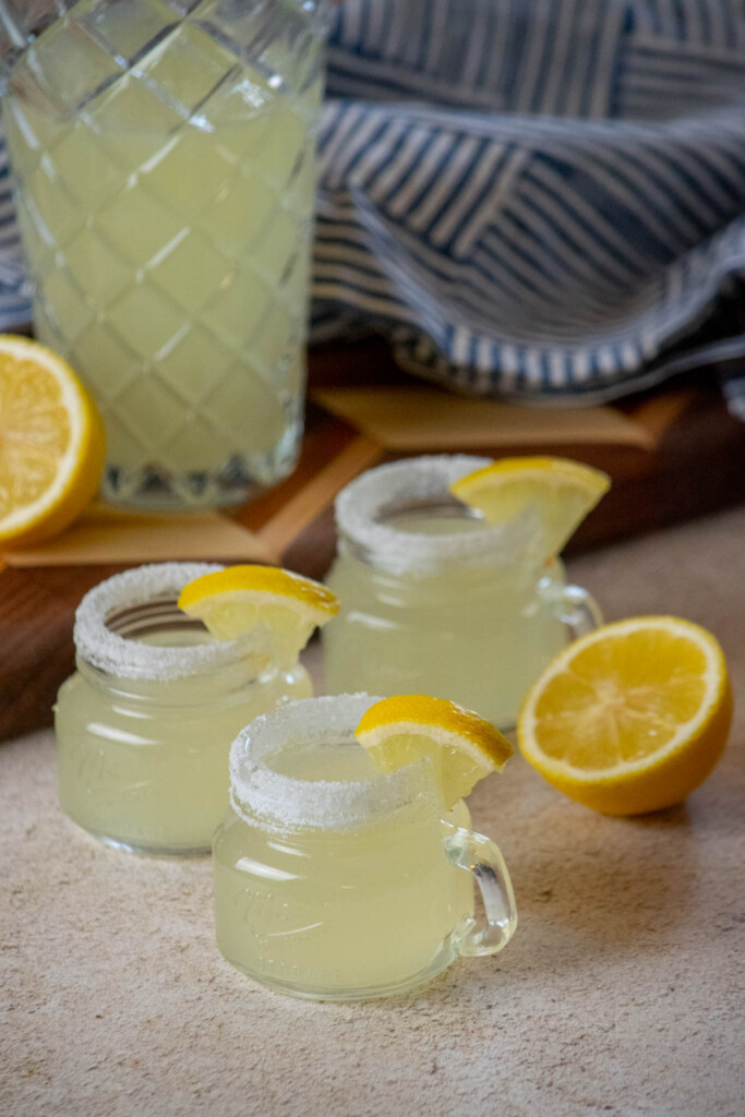 shake the lemon juice, vodka, and simple syrup in a cocktail shaker with ice, and fill each shot glass