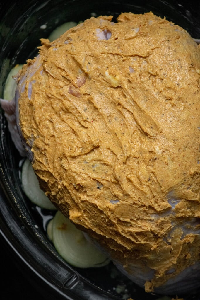 Pat the turkey dry with paper towels. make the compound butter, and slather the turkey in the butter mixture. Place skin side up in the slow cooker.