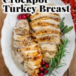 Pinterest pin for juicy and tender Crockpot turkey breast, featuring sliced herb-seasoned turkey with golden skin, homemade gravy, rosemary, and cranberries.