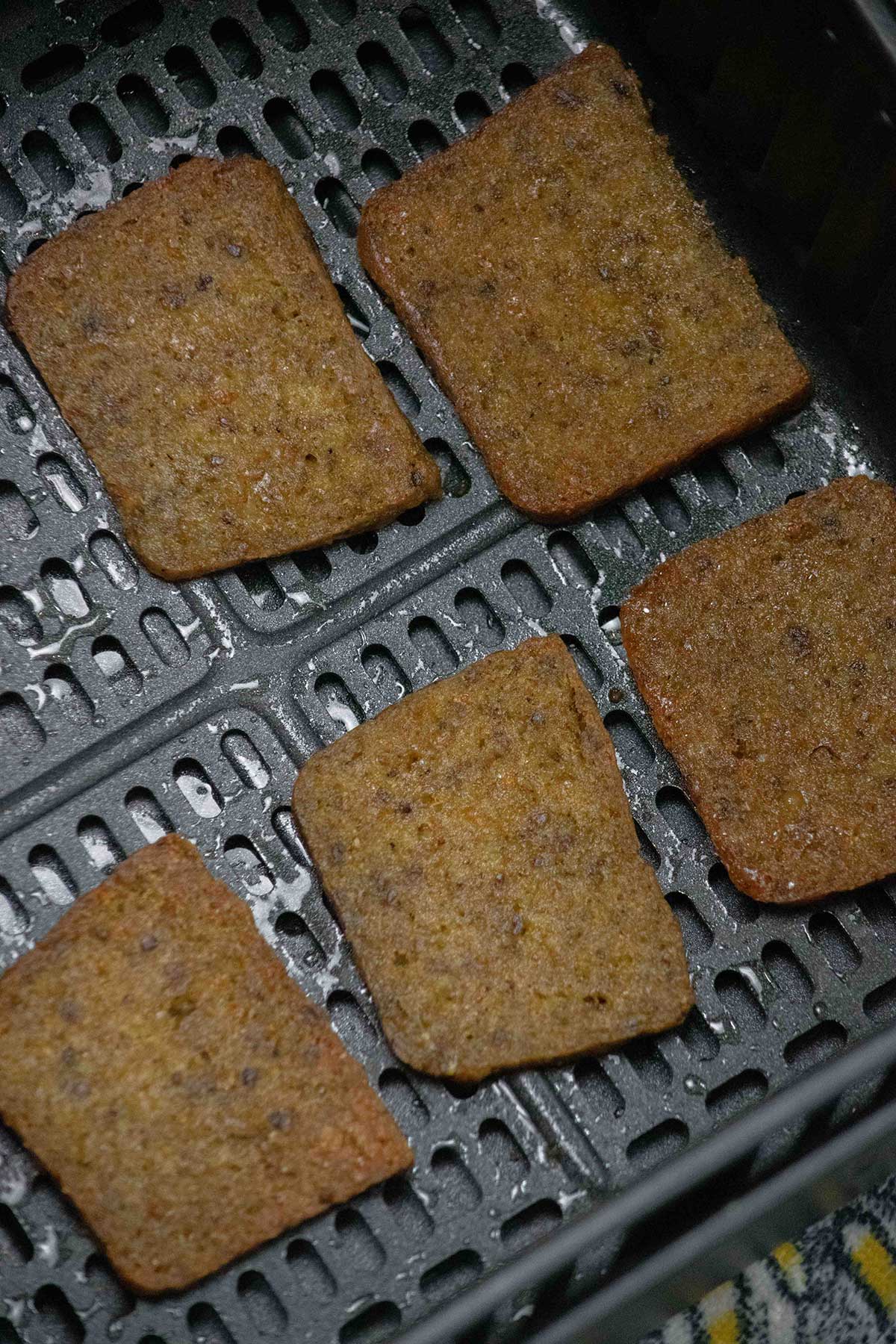 After 10 minutes, flip the slices over and return to the air fryer.