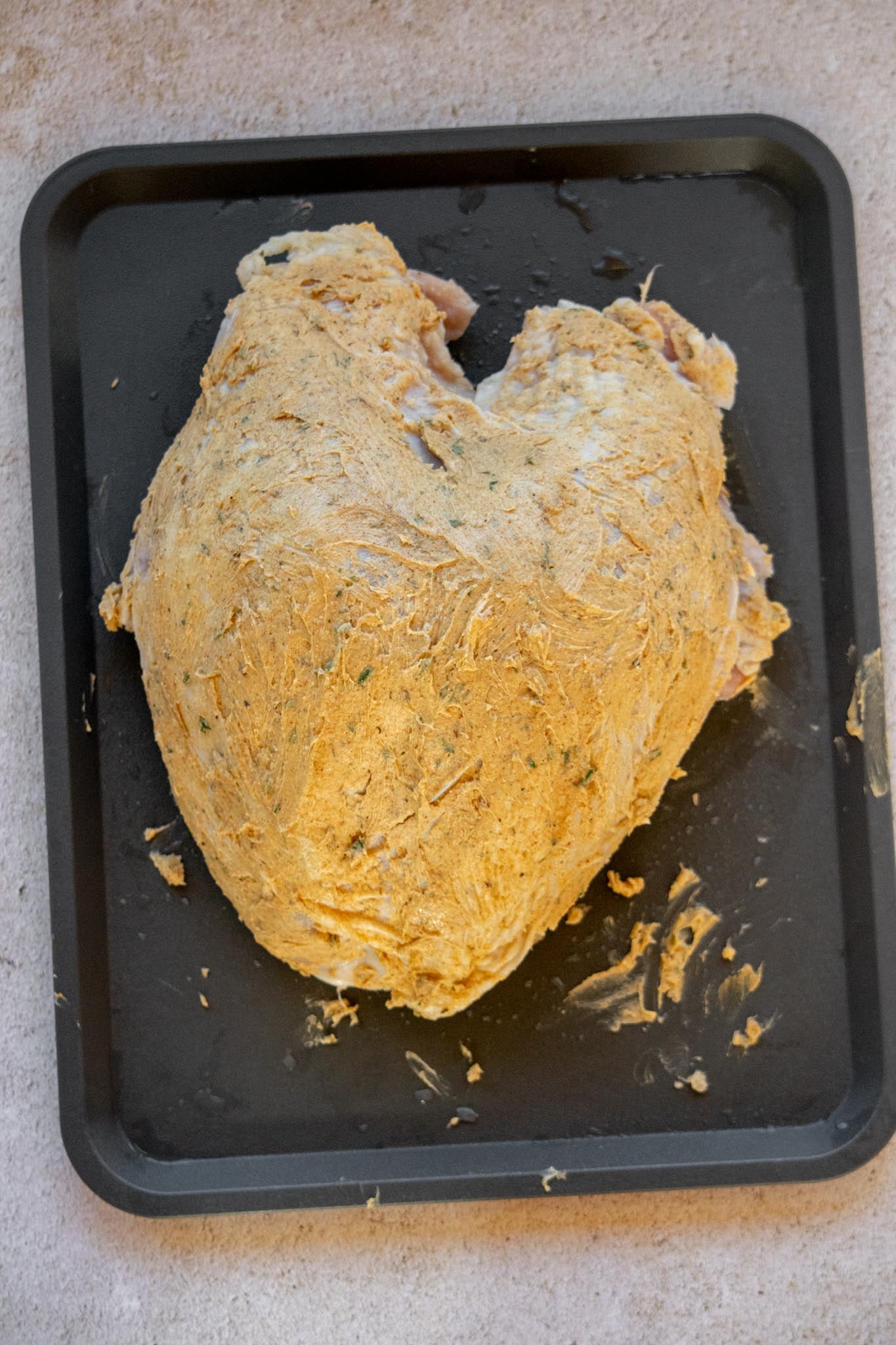 Season the turkey. Pat the turkey dry and gently loosen the skin. Spread two-thirds of the herb butter underneath the skin and rub the rest over the outside.