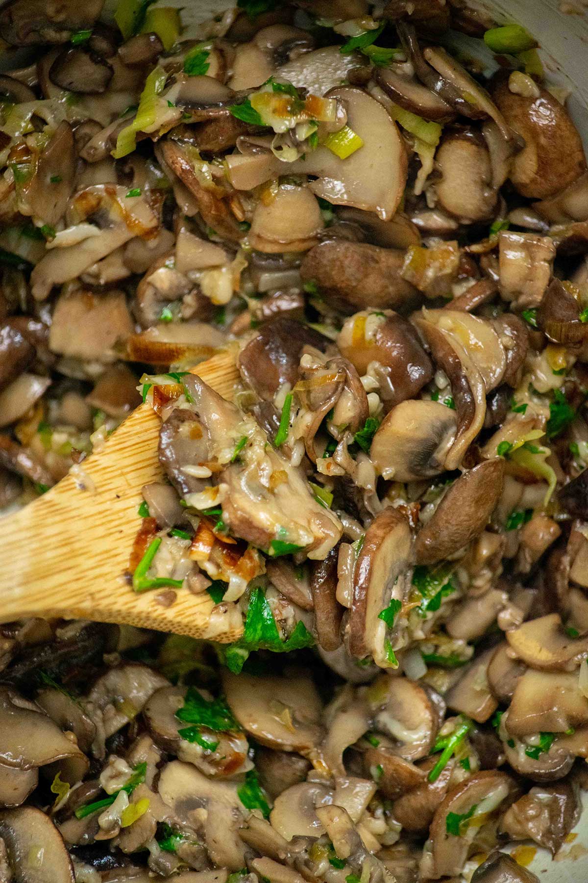 Make the filling. Melt the butter in a large skillet, then cook the leeks until softened and lightly caramelized. Add the mushrooms, season with salt and pepper, and cook until most of the liquid has cooked off. Stir in the garlic, Parmesan, and parsley, then let the filling cool slightly.