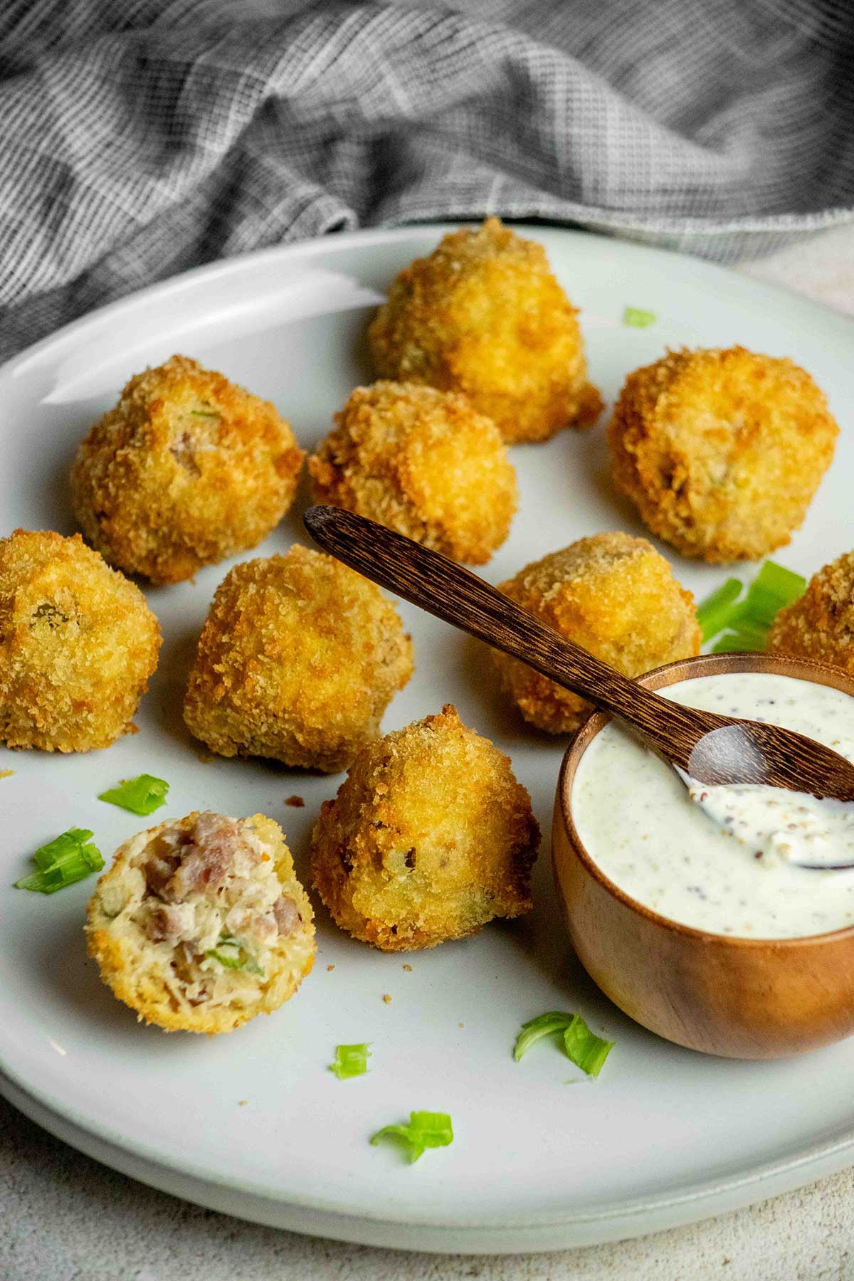 Golden fried sauerkraut balls with bratwurst and sauerkraut filling, served with creamy whole grain mustard dipping sauce.