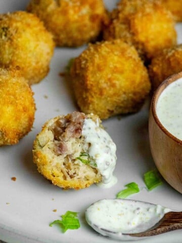 Crispy sauerkraut balls with bratwurst and sauerkraut filling, served with creamy whole grain mustard dipping sauce.