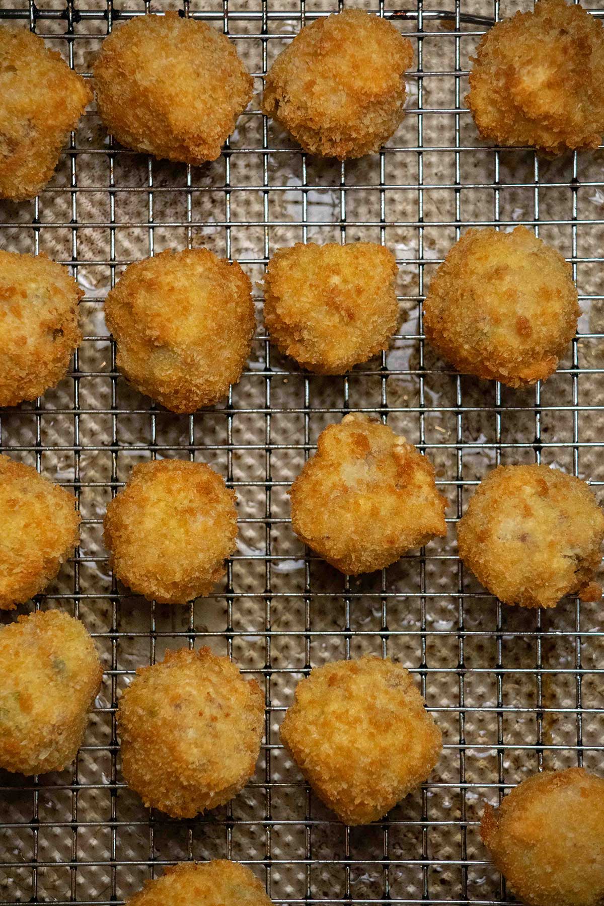 Deep fry until golden. Fry the sauerkraut balls in batches until crisp and golden brown, then transfer to a wire rack or paper towel-lined baking sheet to drain.