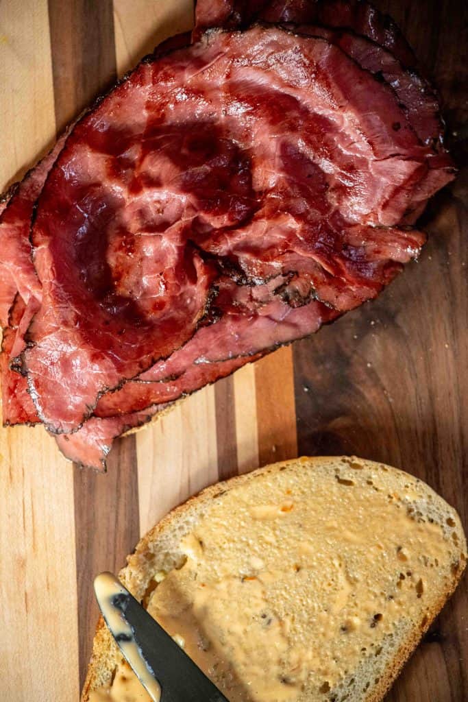 butter the outside of the bread, spread Russian dressing on the inside, crisp the pastrami in a pan with butter, and add to one half of the bread
