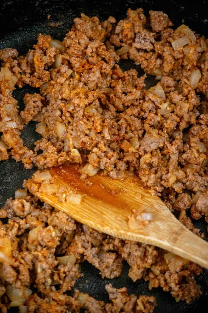 cook onions and beef, then add aromatics and flour