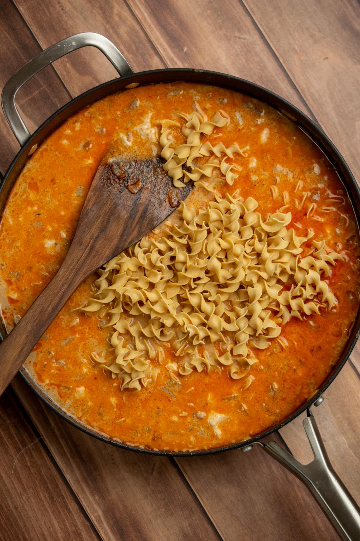 Add the noodles. Stir in the egg noodles and bring the mixture to a boil over high heat.