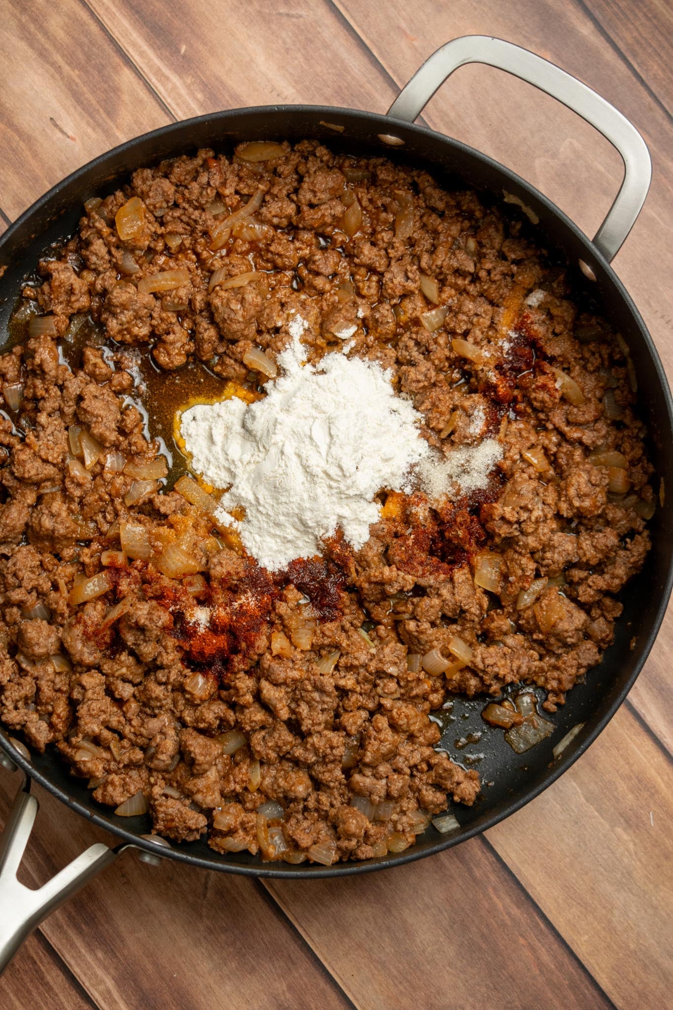 Add the seasonings and flour. Stir in the smoked paprika, salt, sugar if using, black pepper, and flour. Cook for 1 minute.