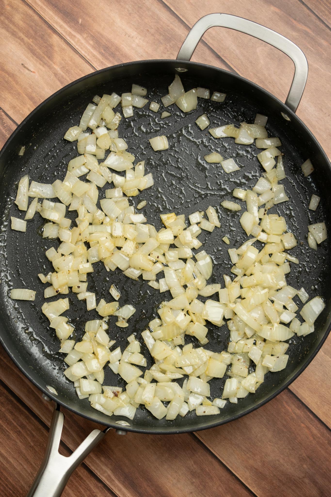 Cook the onion. Melt the butter in a large deep sauté pan or cast iron skillet over medium heat. Add the diced onion and cook for about 5 minutes, until translucent.