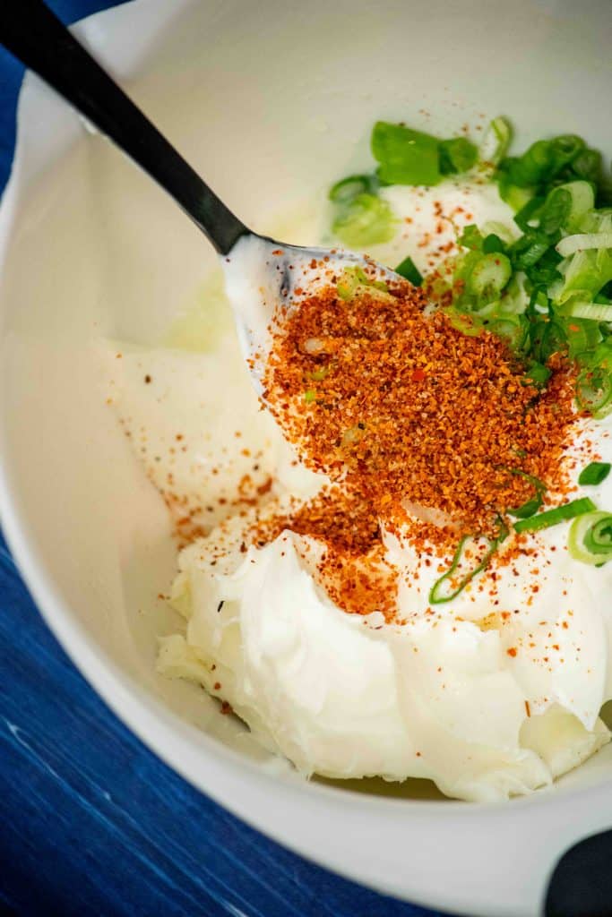 add cream cheese, Tajin, scallions, sour cream, and lime juice to a mixing bowl