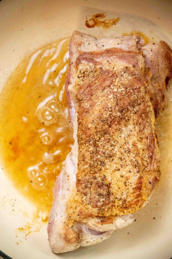 heat oil in Dutch oven, and brown pork on all sides