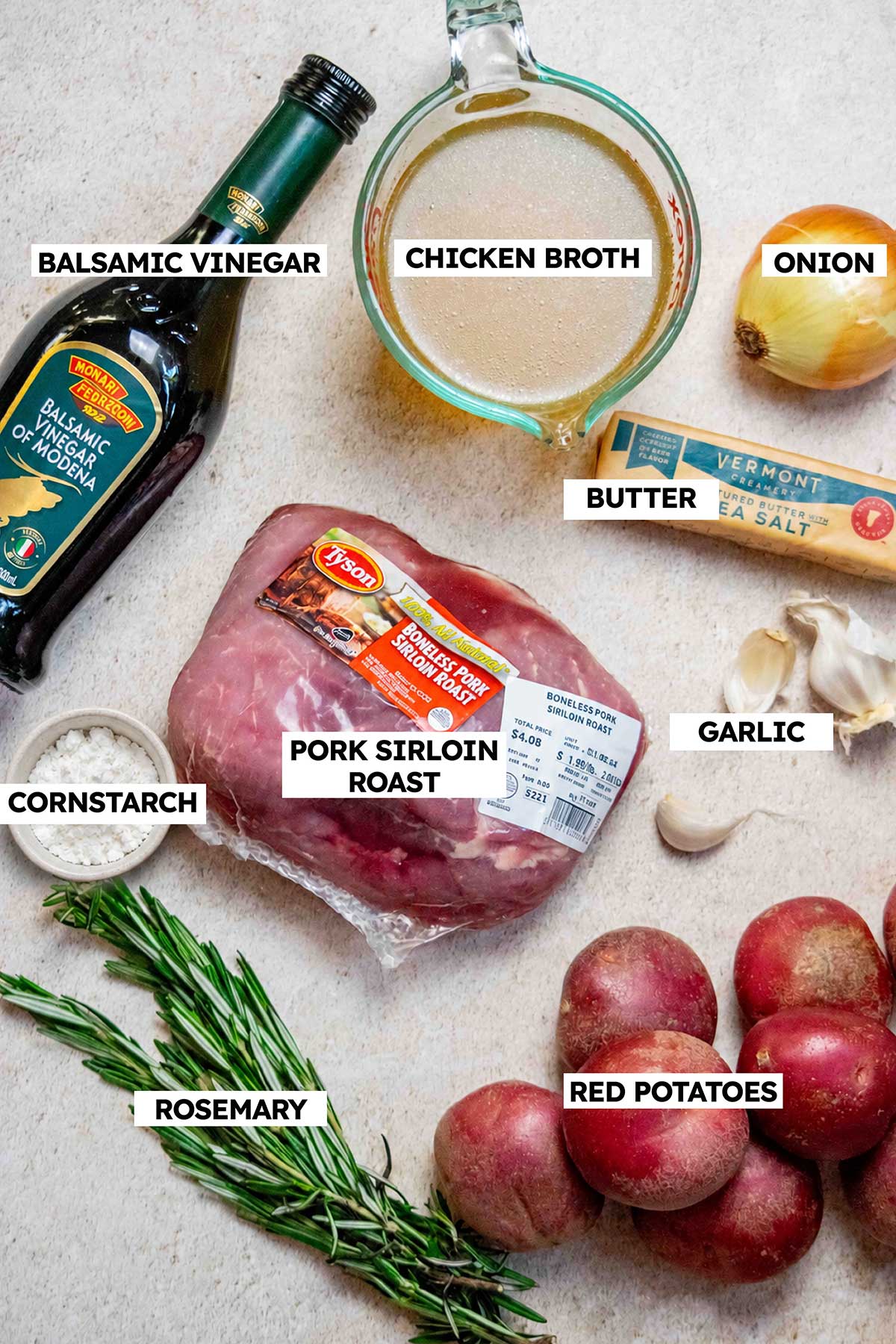 Ingredients for slow cooker pork sirloin roast, including pork sirloin, red potatoes, rosemary, garlic, onion, butter, chicken broth, balsamic vinegar, and cornstarch.