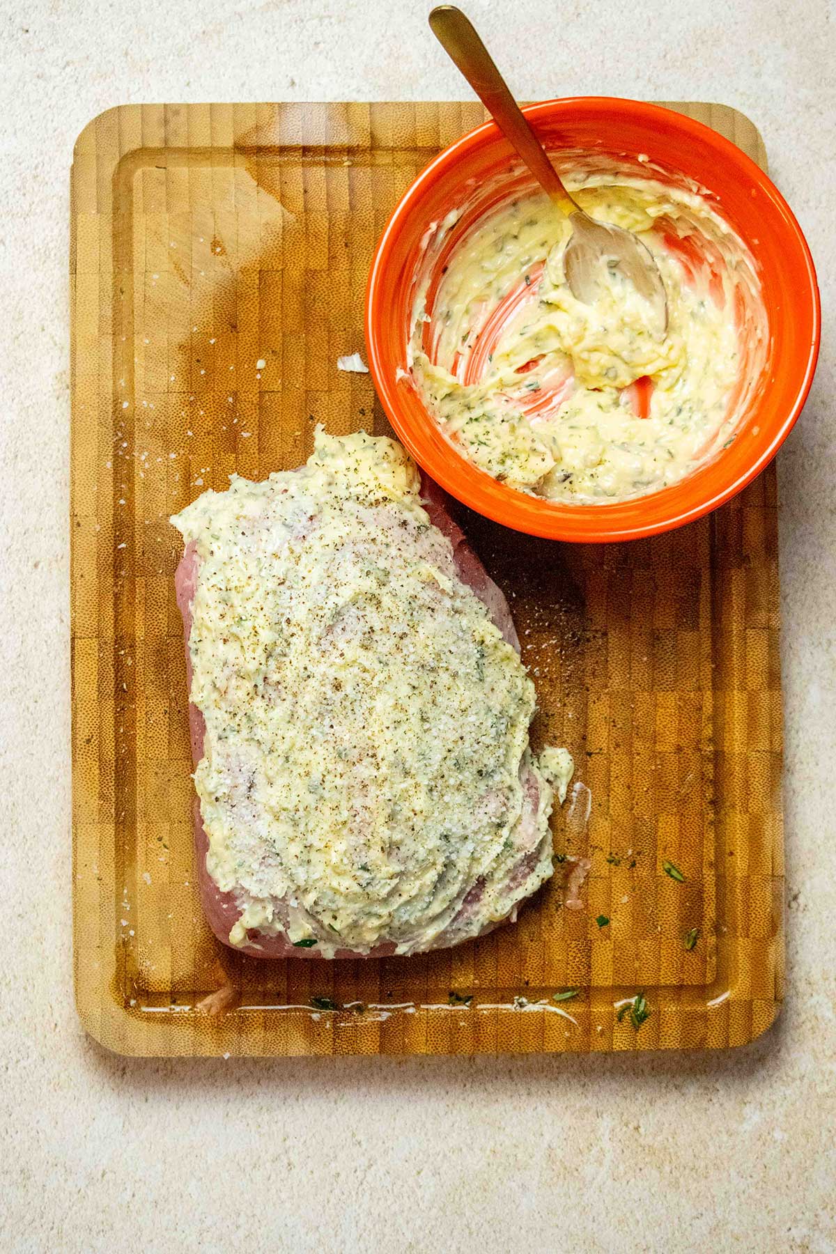Coat and season the pork. Pat the pork sirloin roast dry, coat it all over with the butter mixture, and season generously with salt and black pepper.