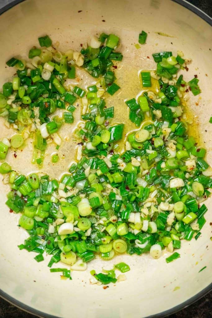 cook scallions and garlic in olive oil, salt, pepper, and red pepper flakes for a few minutes, until starting to soften