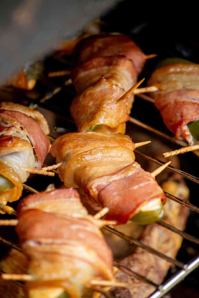 Set poppers on smoker rack, and close smoker. check periodically, about once an hour for doneness