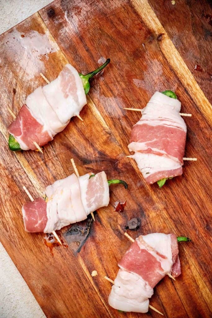 fill the peppers, wrap in bacon, and secure the toothpicks