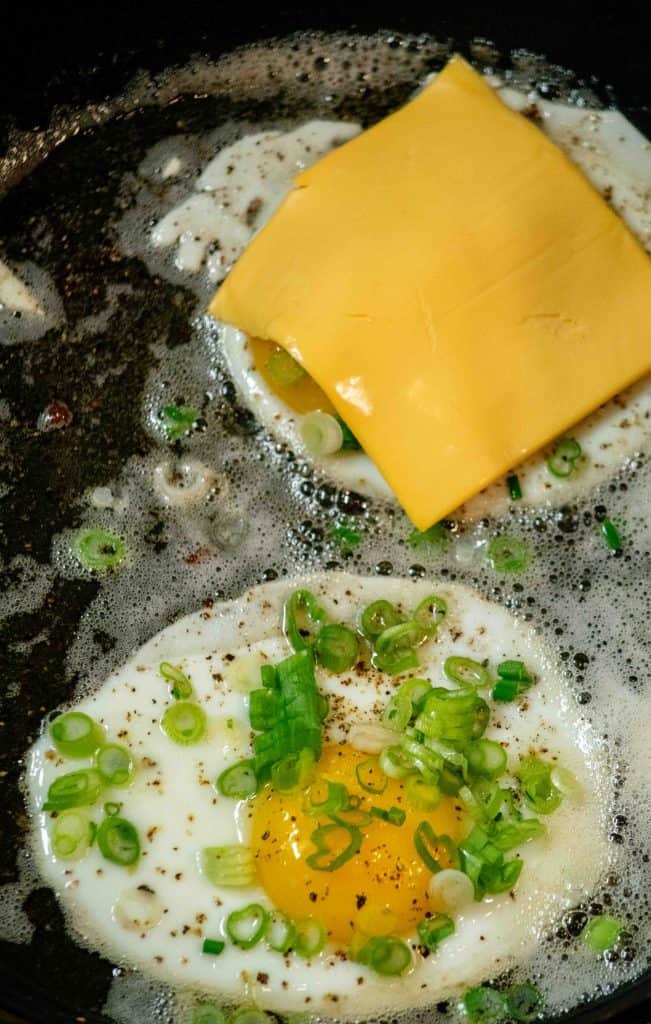 top each egg with a slice of cheese