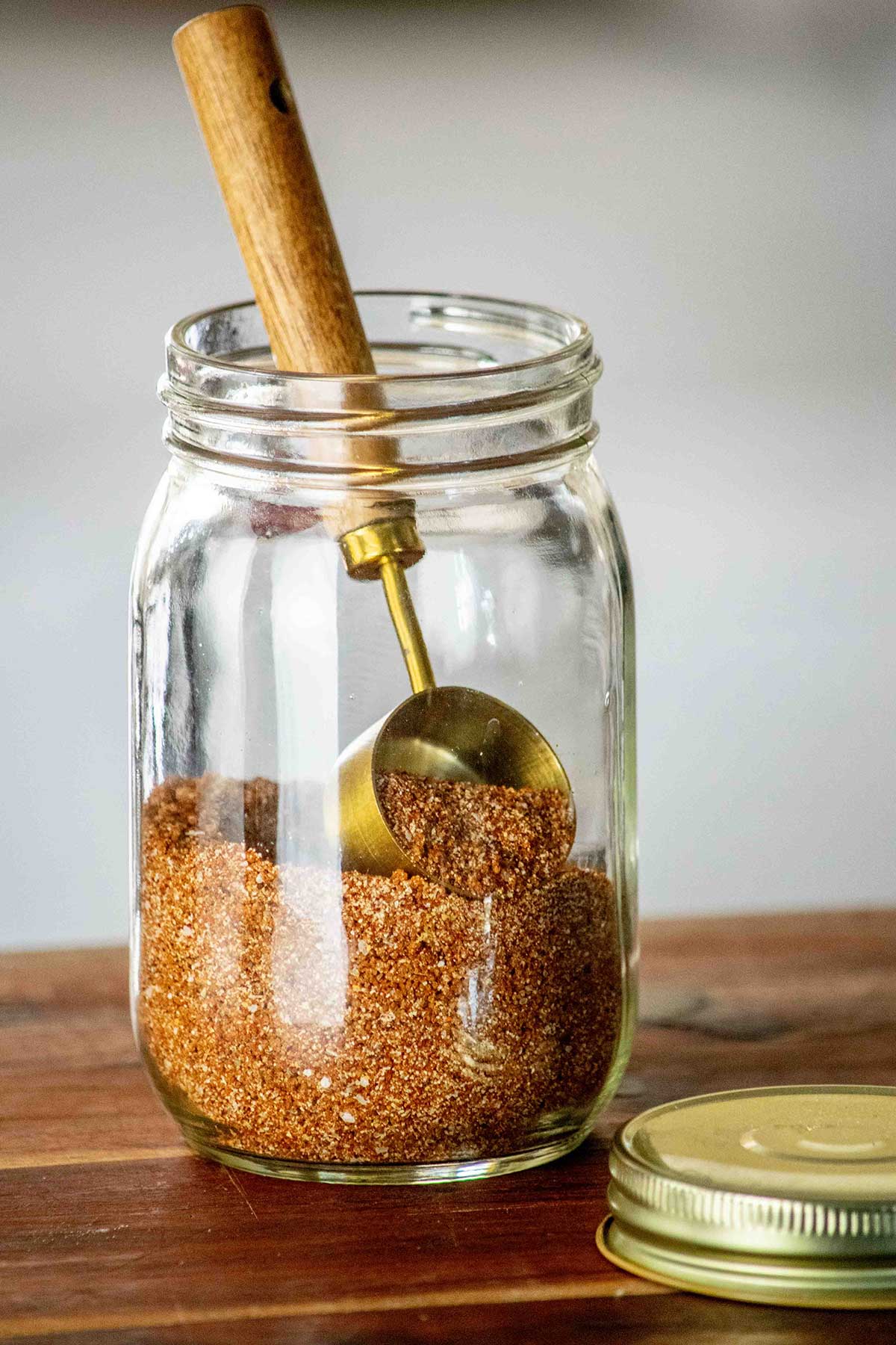 Best Rib Rub recipe in a jar with a scoop.