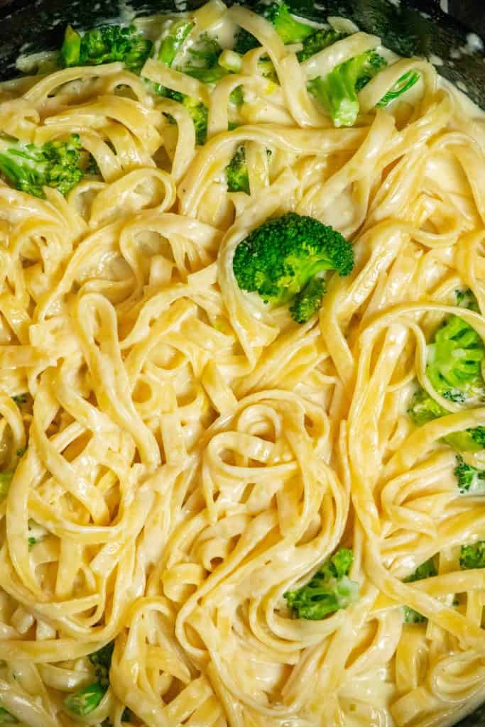 add cooked broccoli and fettuccini and toss to coat
