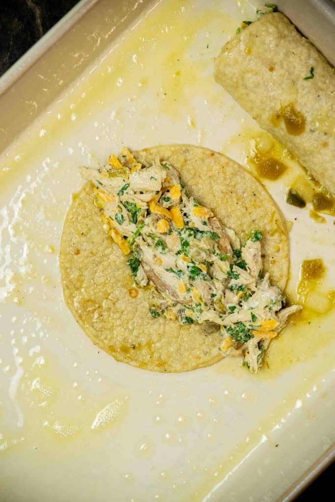 stuff tortillas with filling, and lay seam side down in baking dish