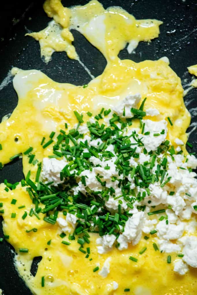 scramble eggs on low until starting to set, then add feta and chives