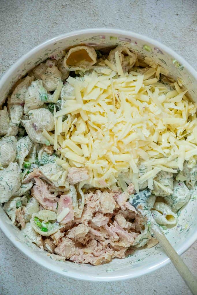 add in drained tuna and shredded cheddar