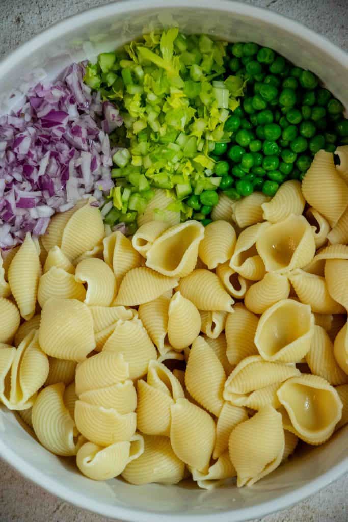 add cooked and drained pasta, peas, red onion and celery to a large bowl