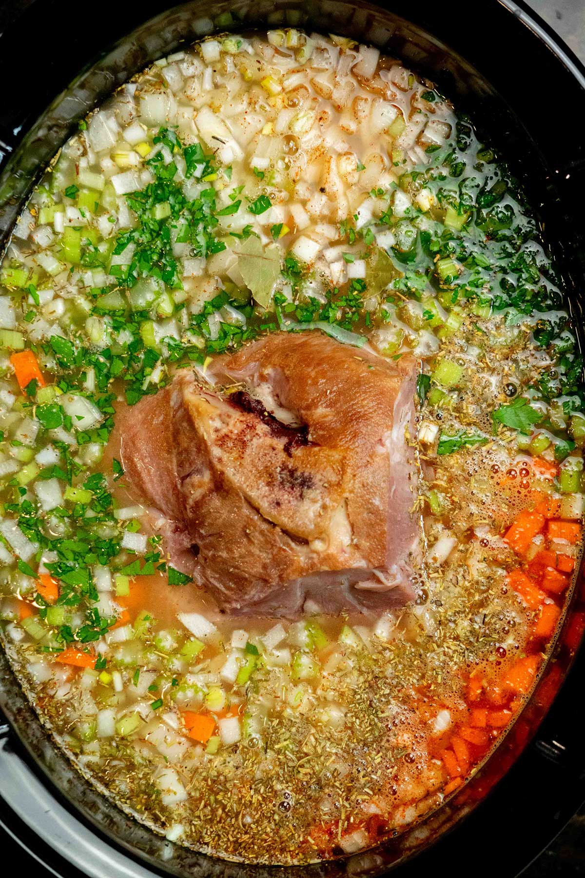 Add the ham bone and cook. Nestle the ham bone into the soup, cover, and cook on HIGH for 6–8 hours, until the beans are tender and the ham easily pulls from the bone.